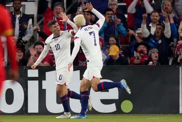 Gio Reyna (center) celebrates with Christian Pulisic after scoring one of his goals against Ghana.