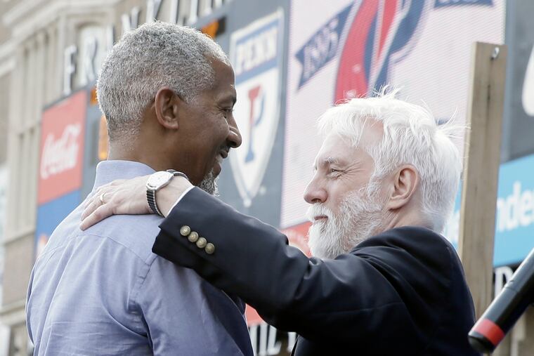 Penn Relays alum Renaldo Nehemiah (left) talks to Relays director Dave Johnson in 2019. Johnson will step down as the event's director.
