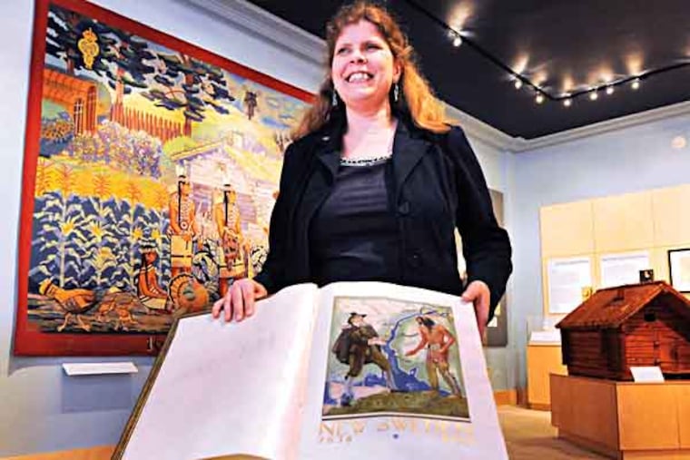 The American-Swedish Museum in South Philly gets itself ready for the King and Queen of Sweden to visit on 5/9/13. Here, Director Tracey Beck with the historic guest book that has been signed by royals and dignitaries over the years. ( APRIL SAUL / Staff )