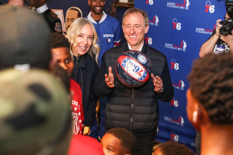 Marjorie and Josh Harris shown after a Sixers game in 2019.
