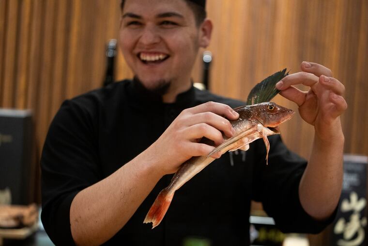 Chef Carlos Wills shows off a fish during the omakase at Ogawa Sushi & Kappo. Wills will be serving up select twists on his sushi at the Inquirer Food Festival.