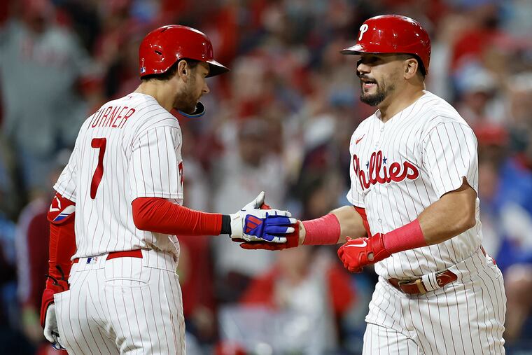 Kyle Schwarber celebrates his solo home run in the sixth inning of Game 2 with Trea Turner.