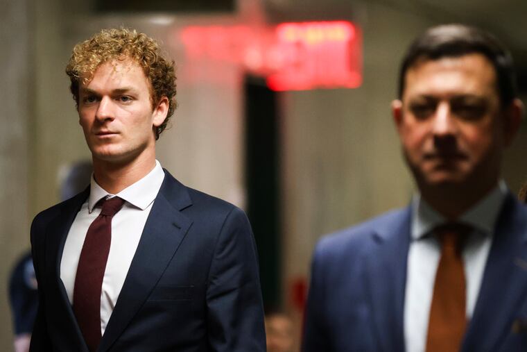 Daniel Penny (left) walks towards the courtroom on Dec. 6 in New York.