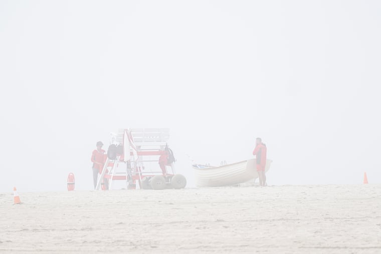Lifeguards gather at a lifeguard tower in rainy and foggy conditions on Memorial Day, Monday, May 25, 2026, in Cape May.