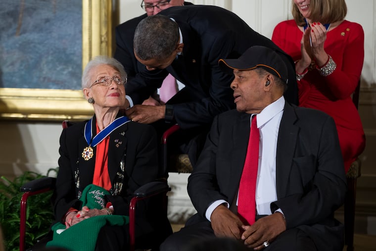 Willie Mays, right, watches as President Barack Obama presents the Presidential Medal of Freedom to NASA mathematician Katherine Johnson during a ceremony in the East Room of the White House, on Tuesday, Nov. 24, 2015, in Washington.