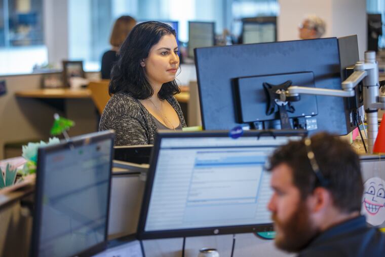 Andrea Spinelli, a health assistant at Accolade for 1 1/2 years, sits at her work station, along with other health assistants and healthcare professisonals, and assists her clients in navigating the healthcare system.