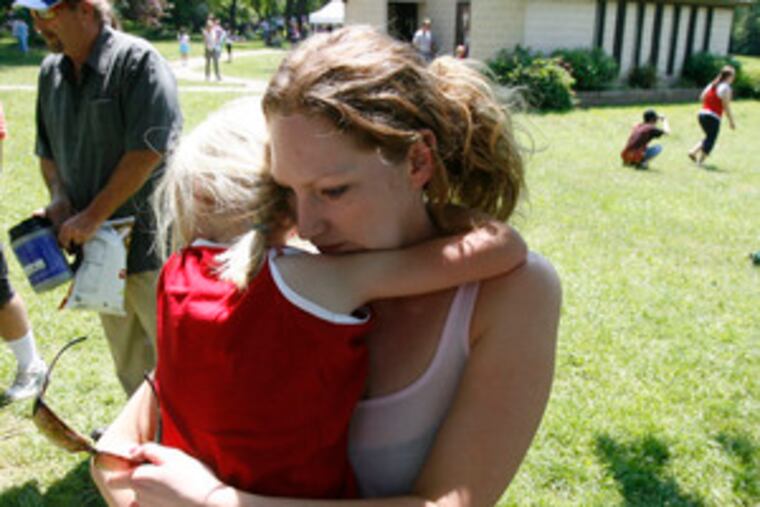 Emily Lanzisera, 6, hugs her birth mother, Lola Henry , as they say goodbye at the annual picnic sponsoredby Adoptions from the Heart. The picnic celebrates relationships of adoptive families with birth parents.