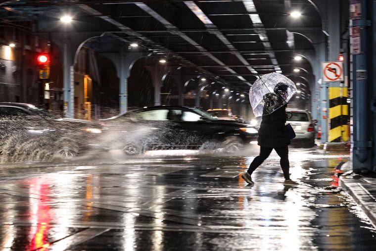 Pedestrians cross Girard at Front Street last month during a wind and rain storm. Gusts to 50 mph are possible Wednesday evening.