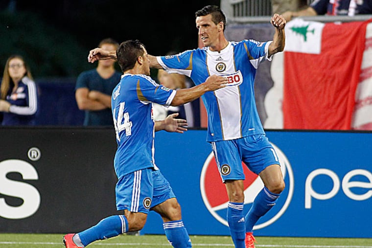 Union midfielder Daniel Cruz celebrates a goal by forward Sebastien Le Toux during the first half. (Stew Milne/USA TODAY Sports)