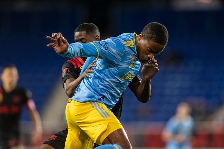 Sergio Santos (right) battles with Drew Yearwood (left) during the first half.