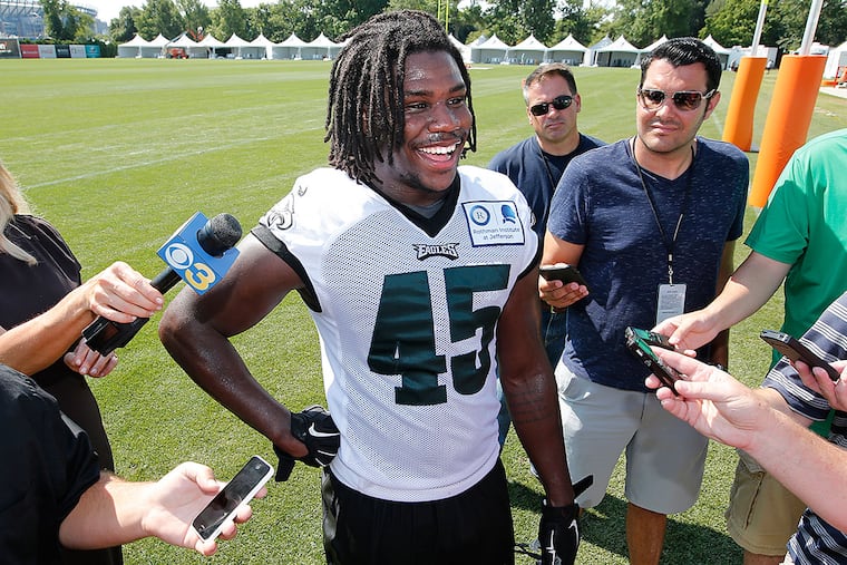 Linebacker Myke Tavarres talks to the media after practice.