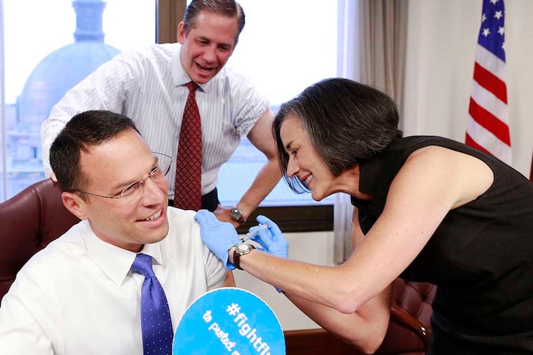 Commissioner Val Arkoosh, M.D. administers flu shots to her commissioner colleagues, Josh Shapiro ( glasses ) and Bruce L. Castor, Jr. at the board's bi-weekly meeting as a way to encourage county residents to take advantage of the county's flu shot program, Thursday October 1, 2015.