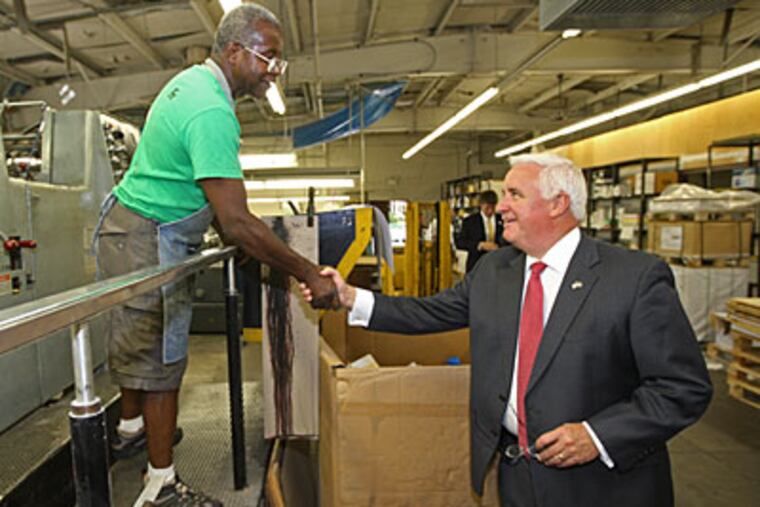 Republican gubernatorial candidate Tom Corbett shakes hands with employee William McNair while touring the Archway Printing plant in Sharon Hill on Tuesday. (Michael Bryant / Staff Photographer)
