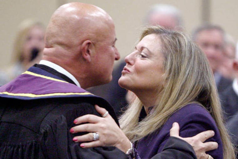 McCaffery and wife Lise Rapaport kiss after he was sworn in as justice. He stepped down in October, and Rapaport, who was her husband's aide for 17 years, also retired. (ELIZABETH ROBERTSON / Staff Photographer)
