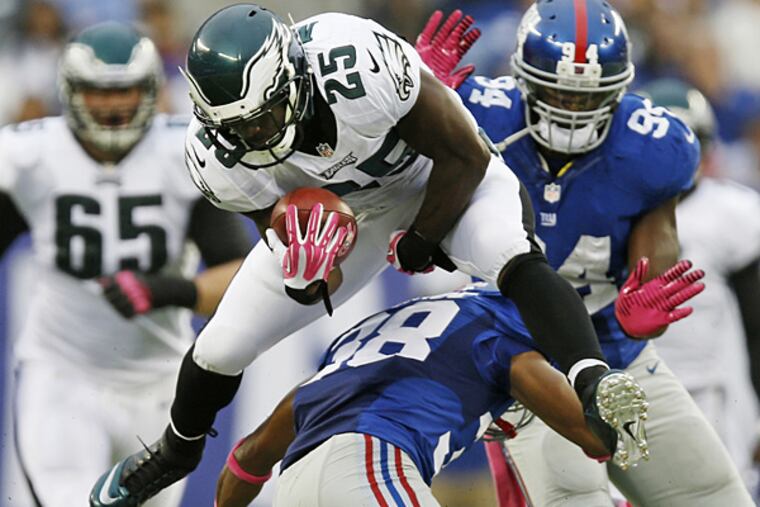 Eagles running back LeSean McCoy leaps over the Giants' Trumaine McBride. (Kathy Willens/AP)