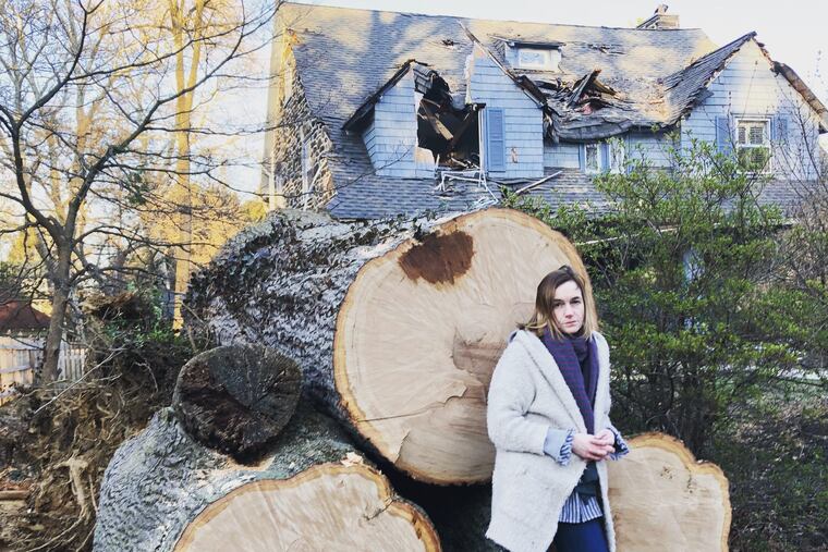 Courtenay Harris Bond in front of what's left of the tree that destroyed the second and third floors of her house in Bala Cynwyd on March 2, 2018.