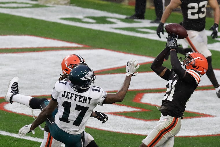 Browns cornerback Denzel Ward intercepts the football in front of Eagles wide receiver Alshon Jeffery late in the fourth quarter on Sunday.