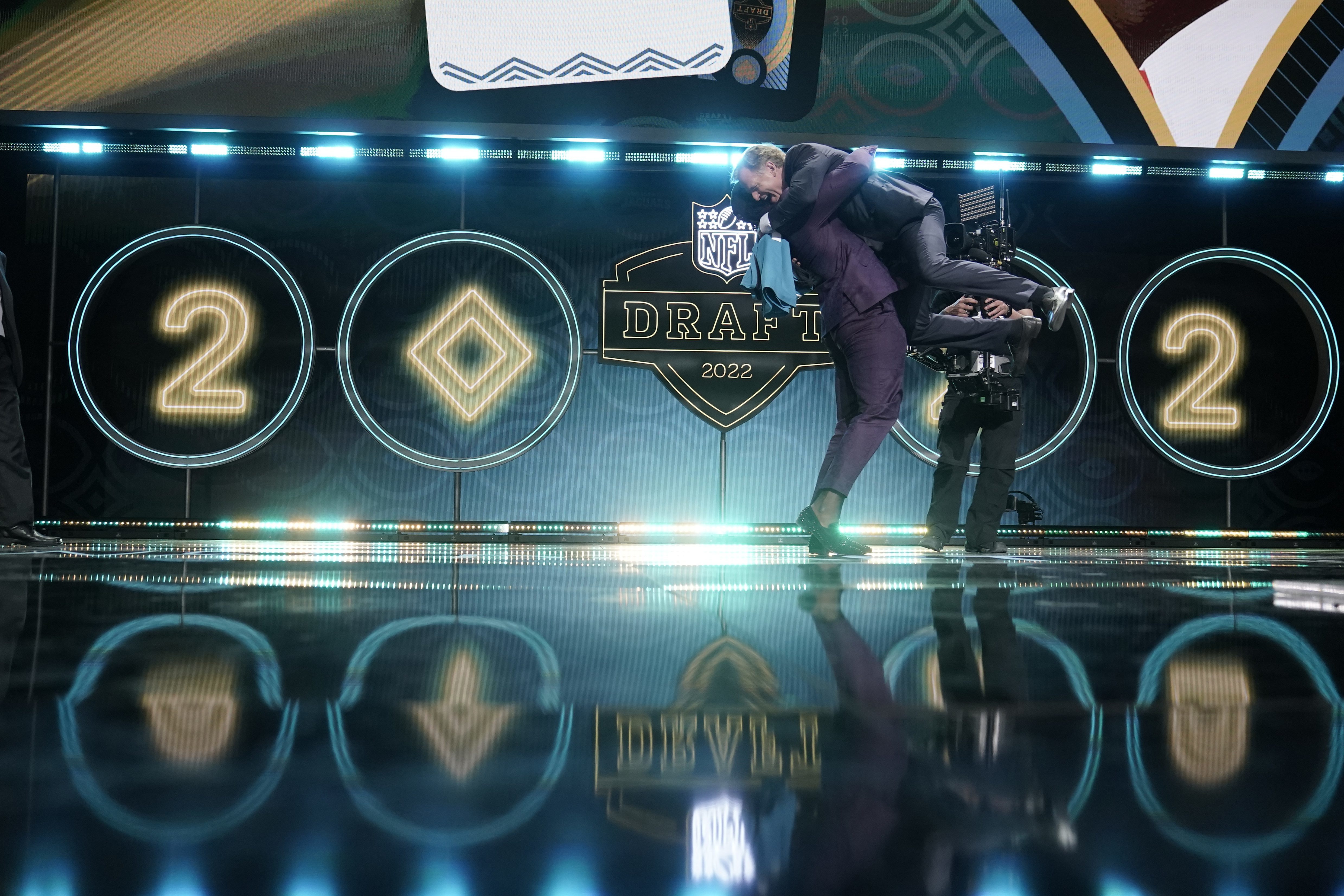 Utah linebacker Devin Lloyd lifts NFL Commissioner Roger Goodell after being chosen by the Jacksonville Jaguars with the 27th pick.