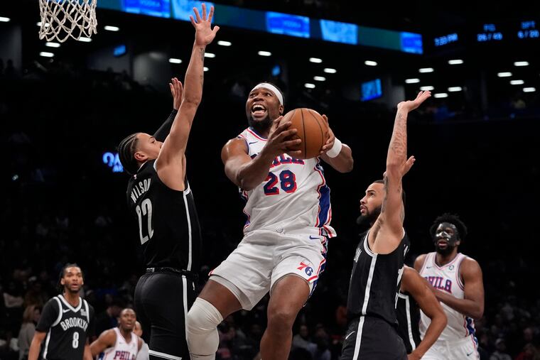 Philadelphia 76ers' Guerschon Yabusele (28) drives past Brooklyn Nets' Jalen Wilson (22) and Tyrese Martin during the second half on Saturday.