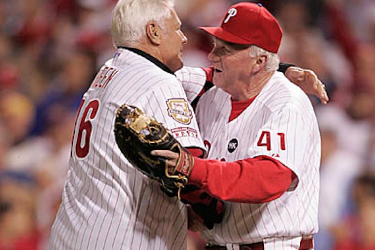 Dallas Green receives a hug from Charlie Manuel after throwing the ceremonial pitch before Game 5 of the NLCS. (David Swanson / Staff Photographer)