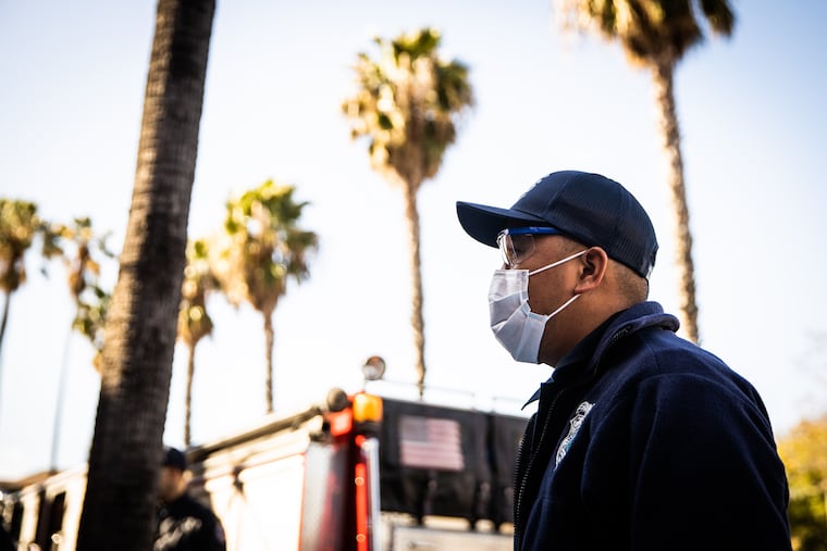 Santa Clara County (Calif.) EMT Twi Ford wears personal protective equipment to protect himself from the coronavirus while responding to a call. Tissue samples taken during autopsies of two individuals who died in February at their homes in Santa Clara County tested positive for the virus.