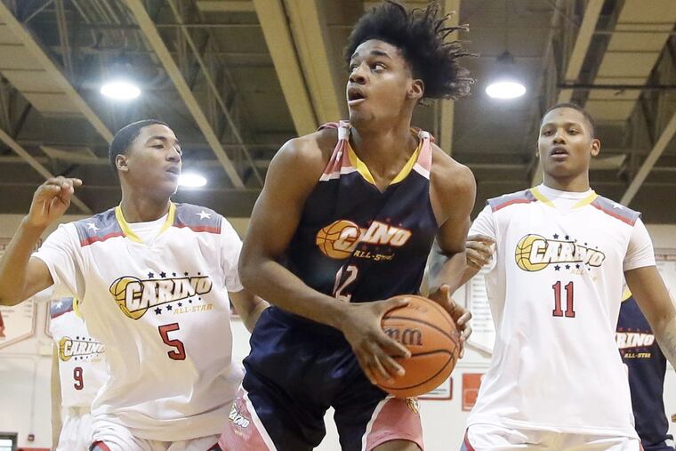 West’s Chris Roe and # 11 D’Andre Thurmond cover East’s Ray Bethea (center) during the Carino Club senior all-star basketball game at Rutgers Camden on March 25, 2018.