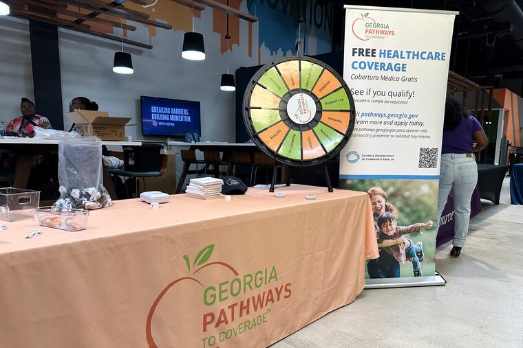 A stand for Georgia Pathways is seen at a job fair in Atlanta, Ga., June 5, 2025. (AP Photo/Sudhin Thanawala)