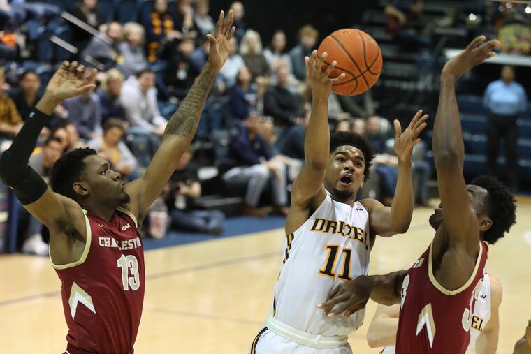 Camren Wynter, center, scored 30 points for the second time this season. FILE PHOTO