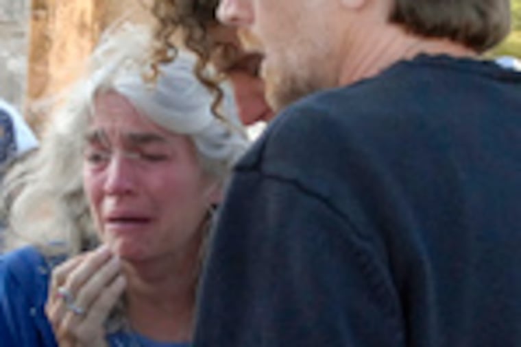 Sue Patterson (left) and Christopher Crane, Taylor Crane's parents, stand near the abandoned mine in Mexico where their son died Friday.