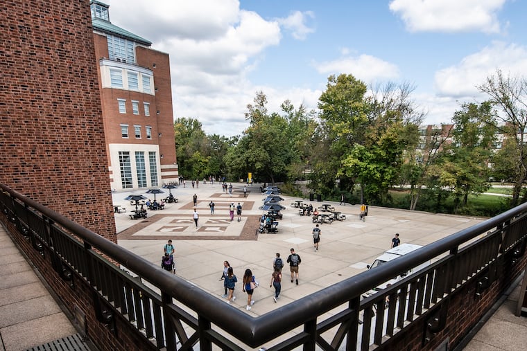 Students walk through campus at Rowan University in Glassboro before the pandemic hit. Rowan is one of several colleges in the region offering students a tuition cut for the fall.