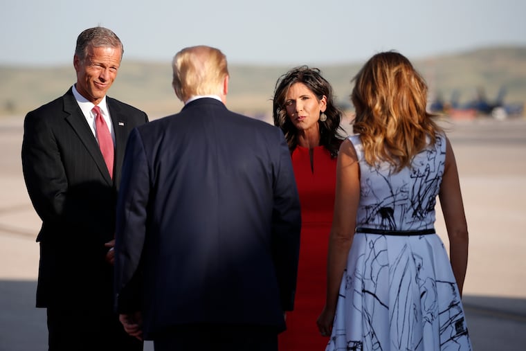 Sen. John Thune, R-S.D., and Gov. Kristi Noem greet President Donald Trump and first Lady Melania Trump upon arrival at Ellsworth Air Force Base, in Rapid City, S.D.