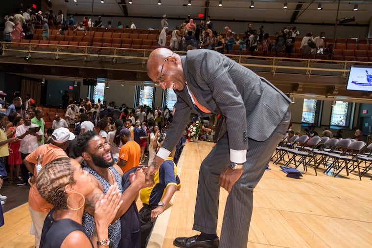 Boys Latin' founder and CEO David Hardy, right, shakes the hand of Antonio Grays as he talks to parents following the charter school's graduation ceremony in this June 2017 file photo. Hardy was announced Wednesday as interim president at Girard College, a boarding school in Fairmount.