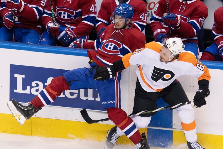 Montreal Canadiens center Jesperi Kotkaniemi (left) and Flyers defenseman Justin Braun mix it up along the boards during Game 4 on Tuesday.