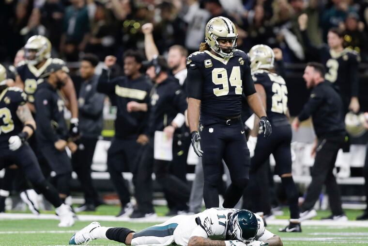 New Orleans Saints defensive end Cameron Jordan stands over Philadelphia Eagles wide receiver Alshon Jeffery after the Saints intercepted the football late in the fourth quarter on Sunday, Jan. 13, 2019 at the Mercedes-Benz Superdome in New Orleans, La. The Eagles lost 20-14, ending their season. (Yong Kim/Philadelphia Inquirer/TNS)
