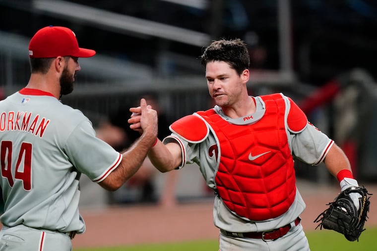Andrew Knapp, right, celebrating with relief pitcher Brandon Workman after Sunday's win over the Braves.