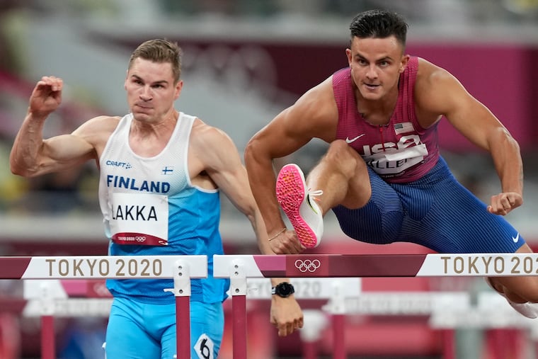 Devon Allen competes alongside Elmo Lakka, of Finland, in a men's 110-meter hurdles heat at the Summer Olympics in Tokyo in 2021.