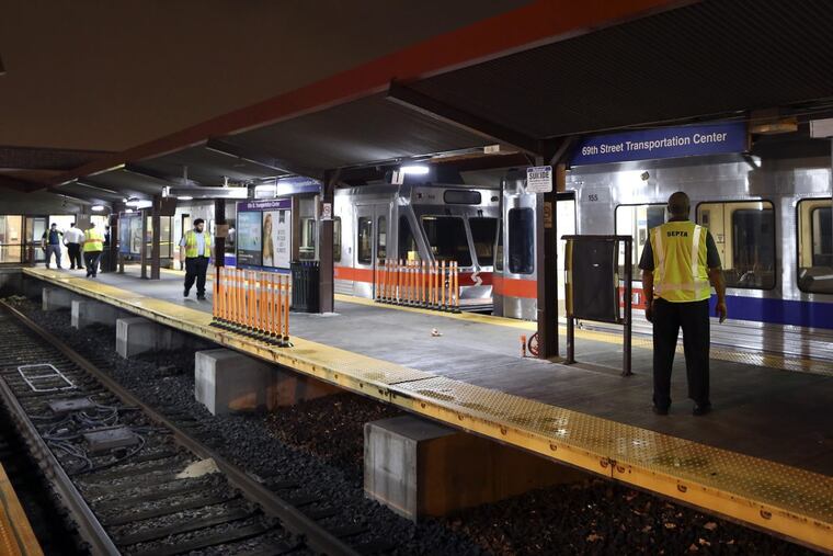 SEPTA officials look over damaged train cars on at the 69th Street Transportation Center in Upper Darby. According to SEPTA officials, a train from the Norristown High Speed Line arriving at the transportation center shortly after midnight struck an unoccupied train car that was sitting at the station platform.