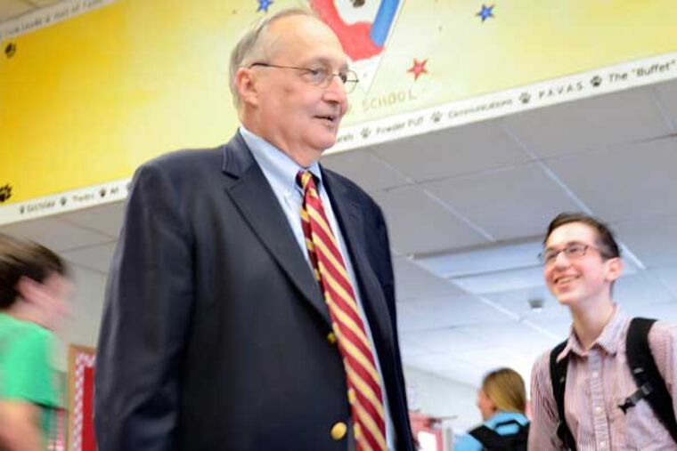 John O'Breza who is retiring as the principal at Cherry Hill East after working for the school district for 45 years, talks to senior Johah Bannett (right) in front lobby as classes change April 15, 2013. ( TOM GRALISH / Staff Photographer )