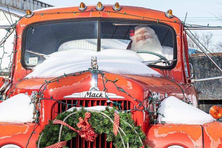 Snow seats on top of a vintage truck with a mannequin depicting Santa Claus at the wheel in Lansdale in December 2020. Ir has been known to snow in December.