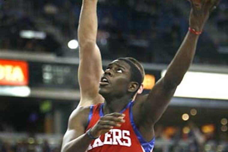 Jrue Holiday drives to the basket past Sacramento Kings defender Spencer Hawes during the first half of last night's game. (AP Photo/Steve Yeater)
