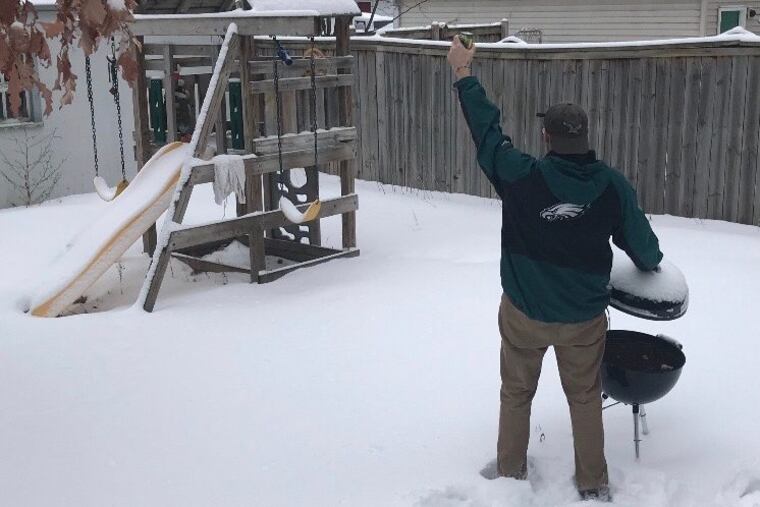 Zoo With Roy toasts in the direction of US Bank Stadium as he considers grilling in the frozen backyard of a rented house in Minneapolis on Feb. 3,2018