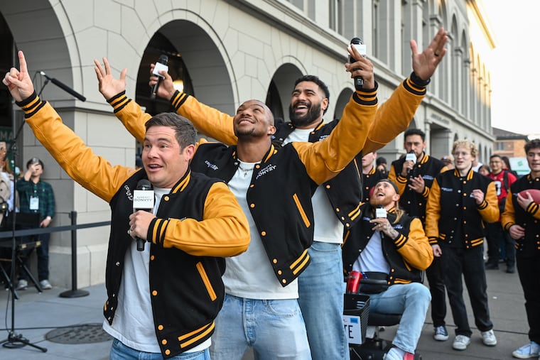 From left, actor Adam Devine, Falcons running back Bijan Robinson, Eagles tackle Jordan Mailata, and 49ers tight end George Kittle perform as The Treblemakers at the Ferry Building in San Francisco.