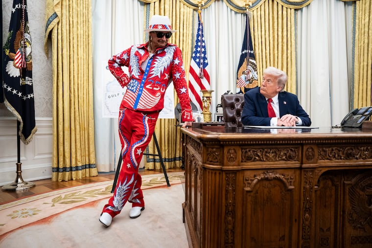 Musician Kid Rock appears alongside President Donald Trump in the Oval Office.
