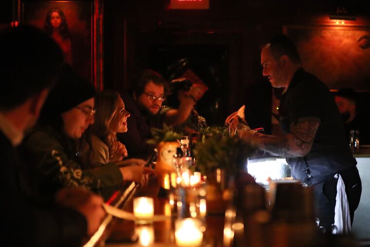 Bartender Nico Diaz prepares a drink talking to customers at the bar in the Ranstead Room on Thursday, February 2, 2023.