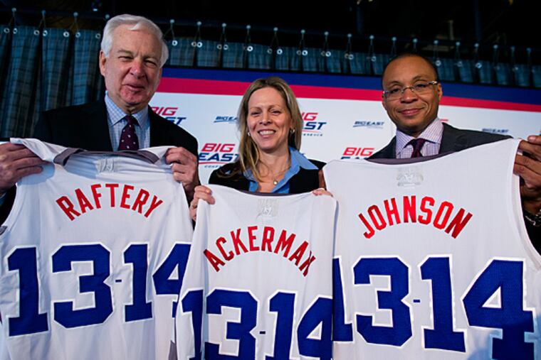 From left, basketball commentator Bill Raftery, Big East Commissioner Val Ackerman, and basketball commentator Gus Johnson hold jerseys during Big East Media Day. (Craig Ruttle/AP)