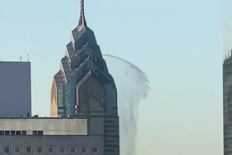 In this image taken from video water gushes out from the side of One Liberty Place on Sunday. An onlooker who took the video said the water continued coming out of the Philadelphia skyscraper for about five minutes before coming to an abrupt halt. (WHYY'S BILLY PENN, @THEPHILLYBERNEDOODLE via AP)