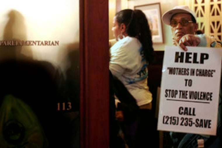 Mothers in Charge, a Philadelphia peace group, got a poster-bearing assist from Clarence Alexander during its round of Capitol lobbying yesterday in support of the lost-or-stolen bill.