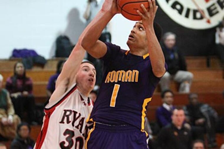 Roman's Shep Garner shoots over Ryan's Gage Galeone during the 4th
quarter. (Steven M. Falk / Staff Photographer)
