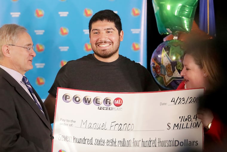 Manuel Franco of West Allis, Wis., winner of the second-highest Powerball lottery in history, attends a news conference at the Wisconsin Department of Revenue in Madison, Wis., on Tuesday, April 23, 2019. At right is Peter Barca, state secretary of revenue, and at right is Cindy Polzin, state lottery director. (John Hart / Wisconsin State Journal via AP)