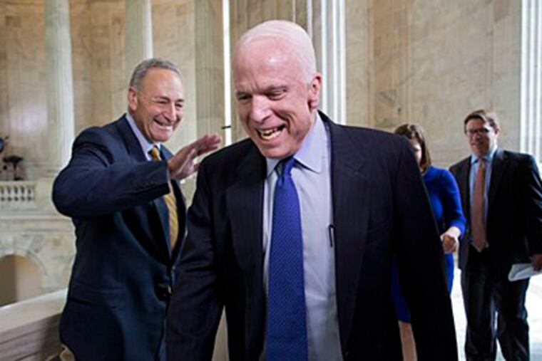 Sen. John McCain, R-Ariz., laughs as he and Sen. Chuck Schumer, D-N.Y., left, cross paths at competing TV news interviews just before a vote in the Senate on legislation to collect sales tax on internet purchases, on Capitol Hill in Washington, Monday, May 6, 2013. (AP Photo/J. Scott Applewhite)
